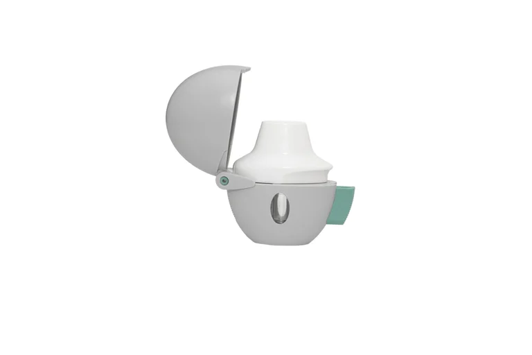 White handheld inhaler device with an open hinged cover, shown against a white background.