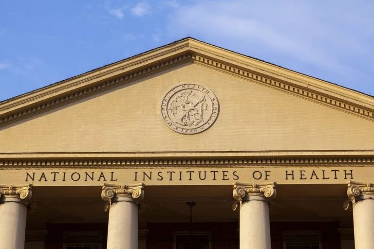 NIH building facade with columns and National Institutes of Health inscription